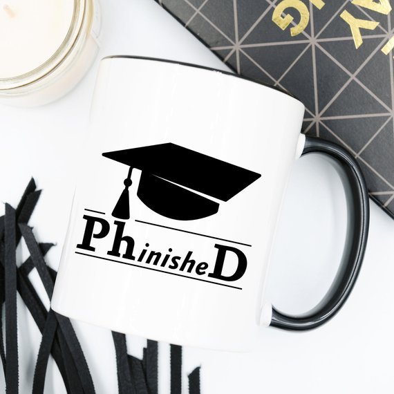 PhinisheD 11oz Coffee Mug featuring a humorous design, perfect for coffee lovers and graduates.